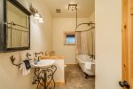 The main level separate full-size bathroom has a stunning clawfoot tub.